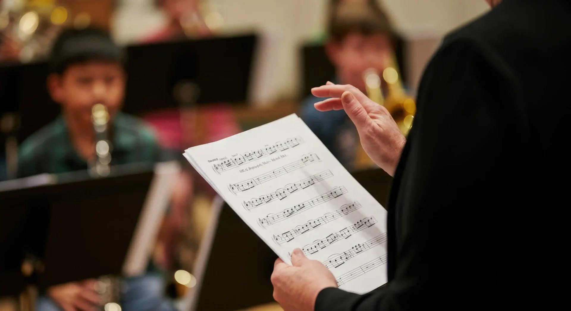 Music instructor teaching students reading sheet music during a class at a music school in Washington DC
