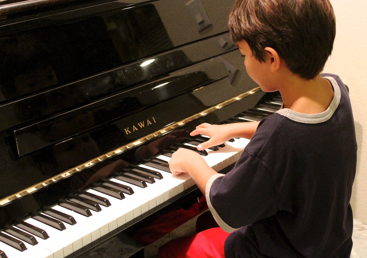 boy learning to play the piano